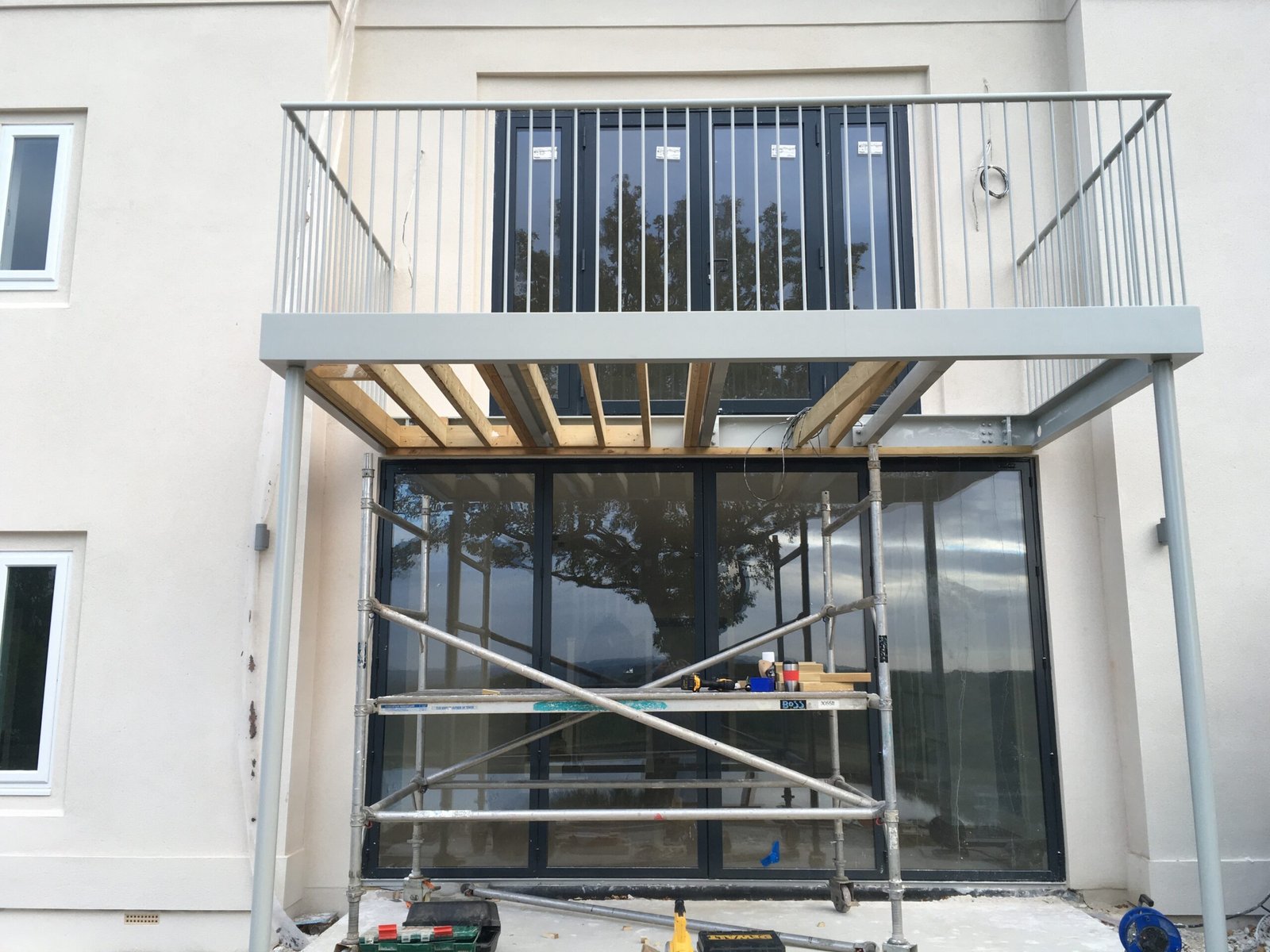 New balcony and glazed doors being installed during a large manor house refurbishment.
